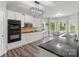 Modern kitchen with stainless steel appliances, white cabinets, and breakfast nook at 9008 Magna Ln, Indian Trail, NC 28079