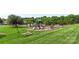 Community playground featuring slides and climbing equipment near pool and picnic area on well-maintained green grass at 9008 Magna Ln, Indian Trail, NC 28079