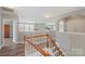 View of the stairway and upper landing with lots of natural light at 9008 Magna Ln, Indian Trail, NC 28079