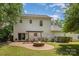 Backyard view of home with brick patio, fire pit and dining area at 9107 Royal Highlands Ct, Charlotte, NC 28277