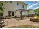 Home exterior with brick patio, fire pit, dining area, and sliding glass doors to the interior at 9107 Royal Highlands Ct, Charlotte, NC 28277