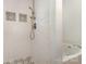 Walk-in shower with white tiling, mosaic tile accents, and modern fixtures and shower-head at 9107 Royal Highlands Ct, Charlotte, NC 28277