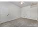 Spacious bedroom with neutral carpet flooring and multiple doors and closets, creating a flexible space at 9107 Royal Highlands Ct, Charlotte, NC 28277