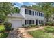 Two-story home with white siding, black shutters, attached garage, and a neatly landscaped lawn for a move-in ready appeal at 9107 Royal Highlands Ct, Charlotte, NC 28277