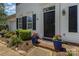 Inviting front entrance with flower-filled blue planters and manicured landscaping, creating a warm and welcoming first impression at 9107 Royal Highlands Ct, Charlotte, NC 28277