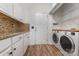 Convenient laundry area including modern washer and dryer units, with added storage shelving space at 9107 Royal Highlands Ct, Charlotte, NC 28277