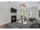 Cozy living room with fireplace, plush sofa, and ample natural light, creating an inviting and relaxing atmosphere at 9107 Royal Highlands Ct, Charlotte, NC 28277
