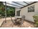 Covered patio featuring a stone table with four chairs surrounded by brick pavers at 9107 Royal Highlands Ct, Charlotte, NC 28277