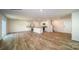Open-concept living room with hardwood floors, white trim, and modern kitchen appliances in a bright space at 921 Two Brothers Ln, York, SC 29745