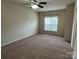 Spacious bedroom featuring a ceiling fan and a window allowing natural light at 9593 Camberley Nw Ave, Concord, NC 28027