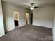 Bright bedroom with a ceiling fan, carpet, and doorway to bathroom and closet at 9593 Camberley Nw Ave, Concord, NC 28027