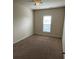 Bedroom with a ceiling fan, neutral walls, plush carpet and window at 9593 Camberley Nw Ave, Concord, NC 28027