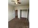 Bedroom featuring carpeted floors and doorway to closet space at 9593 Camberley Nw Ave, Concord, NC 28027