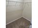 Walk-in closet with carpeted flooring and shelving unit perfect for storage at 9593 Camberley Nw Ave, Concord, NC 28027