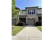Charming townhome boasts a brick facade, attached garage, and manicured front yard with lush landscaping at 9593 Camberley Nw Ave, Concord, NC 28027