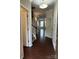 Inviting entryway with hardwood floors, staircase with white railing, and neutral wall paint at 9593 Camberley Nw Ave, Concord, NC 28027