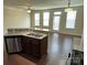Open kitchen with stainless steel appliances, granite countertops, breakfast bar, and dark hardwood floors at 9593 Camberley Nw Ave, Concord, NC 28027