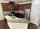 Updated kitchen with stainless steel appliances, granite countertops, and ample cabinet space at 9593 Camberley Nw Ave, Concord, NC 28027