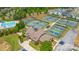 Aerial view of community tennis courts, swimming pool, and recreation center surrounded by homes at 10016 St Kitts Landing Ln, Charlotte, NC 28278