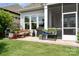 Charming patio with decorative plants, outdoor seating, and a grill for entertaining at 10016 St Kitts Landing Ln, Charlotte, NC 28278