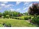 Expansive backyard with lush green grass and mature trees offers a serene and private outdoor space at 10016 St Kitts Landing Ln, Charlotte, NC 28278