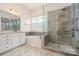 Modern bathroom features a glass-enclosed shower, soaking tub, and dual vanity sinks at 10016 St Kitts Landing Ln, Charlotte, NC 28278