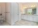 Bright bathroom featuring double sinks, granite countertops, and modern fixtures at 10016 St Kitts Landing Ln, Charlotte, NC 28278
