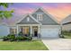 Charming single-Gathering home featuring a manicured front yard, two-car garage, and inviting front porch at 10016 St Kitts Landing Ln, Charlotte, NC 28278