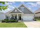 Charming single-Gathering home featuring a manicured front yard, two-car garage, and inviting front porch at 10016 St Kitts Landing Ln, Charlotte, NC 28278