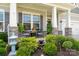 Inviting front porch with stone accents, elegant seating, and lush landscaping with a tranquil fountain at 10016 St Kitts Landing Ln, Charlotte, NC 28278