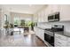 Bright kitchen featuring white cabinets, granite countertops, and stainless steel appliances at 10016 St Kitts Landing Ln, Charlotte, NC 28278