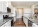 Spacious kitchen featuring stainless steel appliances, granite countertops, and ample cabinet space at 10016 St Kitts Landing Ln, Charlotte, NC 28278