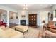 Cozy living room featuring a fireplace and large windows, leading to a connected bedroom at 10016 St Kitts Landing Ln, Charlotte, NC 28278