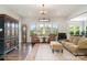 Bright living room featuring large windows and hardwood floors that create an airy and inviting space at 10016 St Kitts Landing Ln, Charlotte, NC 28278