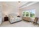 Serene main bedroom features tray ceiling, large windows, and neutral decor at 10016 St Kitts Landing Ln, Charlotte, NC 28278