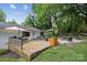 Spacious backyard with a patio, umbrella, seating area, firepit and beautiful landscaping at 1021 Nancy Dr, Charlotte, NC 28211