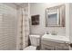 Bathroom showcasing a tiled shower, a white sink, and a decorative mirror at 1021 Nancy Dr, Charlotte, NC 28211