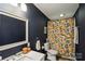 Modern bathroom featuring dark walls, a white sink, and a shower with a patterned curtain at 1021 Nancy Dr, Charlotte, NC 28211