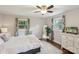 Cozy bedroom with a ceiling fan, large windows, and neutral decor, creating a relaxing space at 1021 Nancy Dr, Charlotte, NC 28211