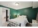 Bedroom with dark-green walls and a comfortable bed with white linens at 1021 Nancy Dr, Charlotte, NC 28211