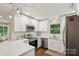 Modern kitchen with white cabinets, stainless steel appliances, and quartz countertops at 1021 Nancy Dr, Charlotte, NC 28211