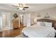 Serene main bedroom with a walk-in closet, ensuite bathroom, and a decorative ceiling fan at 1021 Nancy Dr, Charlotte, NC 28211
