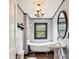Charming bathroom with clawfoot tub, pedestal sink, and vintage fixtures at 107 Hinton St, Chester, SC 29706