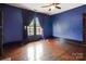Bedroom featuring wood floors, a ceiling fan and purple drapes at 107 Hinton St, Chester, SC 29706