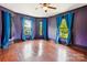 Bedroom with hardwood floors, blue walls and drapes and lots of natural light at 107 Hinton St, Chester, SC 29706