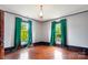 Bright bedroom with hardwood floors, decorative light fixture, and green curtains at 107 Hinton St, Chester, SC 29706