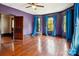 Spacious bedroom featuring hardwood floors, blue curtains, and plenty of natural light at 107 Hinton St, Chester, SC 29706