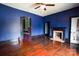 Spacious bedroom with hardwood floors, fireplace, and uniquely painted trim and doors at 107 Hinton St, Chester, SC 29706