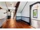 Spacious hallway featuring beautiful wood floors, decorative trim, and a staircase leading to the upper level at 107 Hinton St, Chester, SC 29706