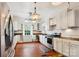 Bright kitchen features white cabinets, modern appliances, wooden countertops and hardwood flooring at 107 Hinton St, Chester, SC 29706
